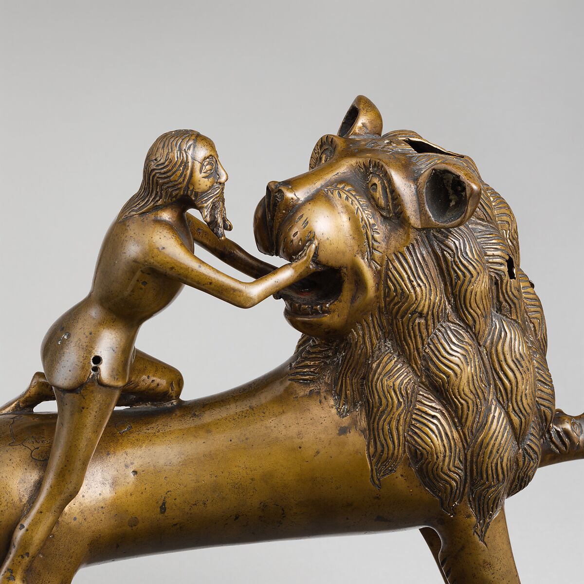 Aquamanile in the Form of Samson and
the Lion, Bronze; quaternary copper alloy (approx. 78% copper, approx. 10% zinc, approx. 6% tin, approx. 5% lead) with natural patina. Remnants of the iron armature are in the lion’s legs and the figure of Samson., Northern European (?), possibly German