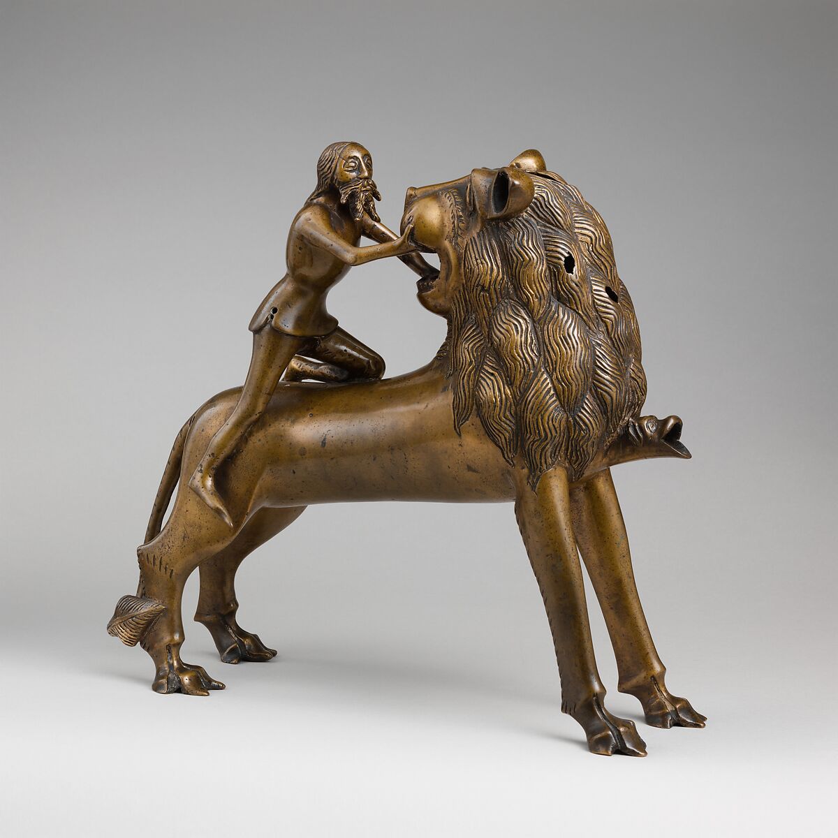 Aquamanile in the Form of Samson and
the Lion, Bronze; quaternary copper alloy (approx. 78% copper, approx. 10% zinc, approx. 6% tin, approx. 5% lead) with natural patina. Remnants of the iron armature are in the lion’s legs and the figure of Samson., Northern European (?), possibly German