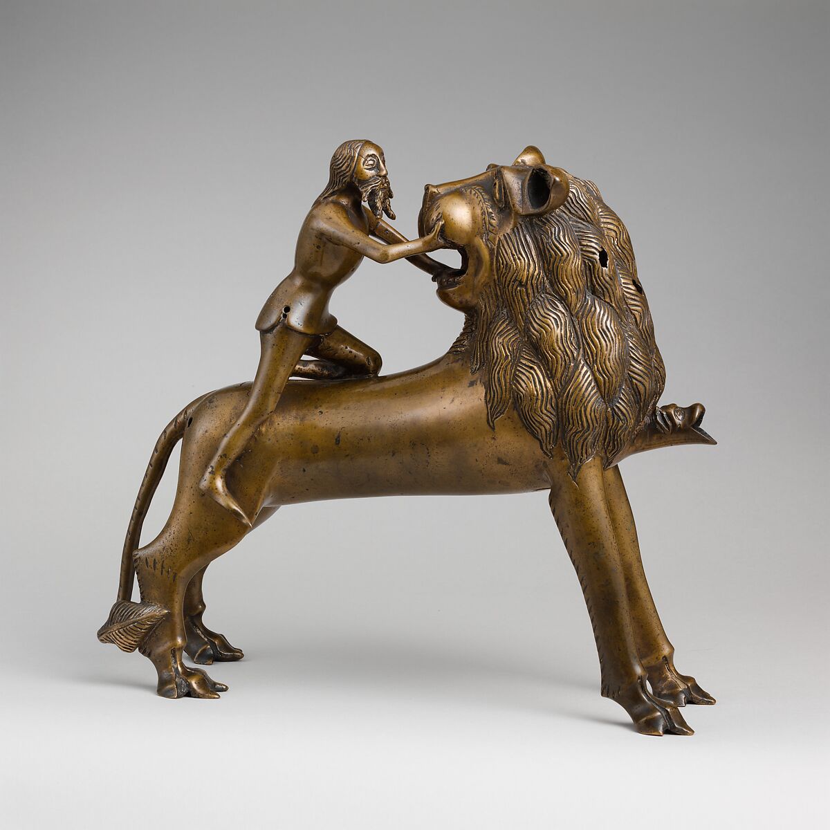 Aquamanile in the Form of Samson and
the Lion, Bronze; quaternary copper alloy (approx. 78% copper, approx. 10% zinc, approx. 6% tin, approx. 5% lead) with natural patina. Remnants of the iron armature are in the lion’s legs and the figure of Samson., Northern European (?), possibly German