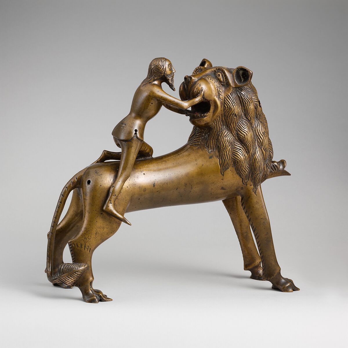 Aquamanile in the Form of Samson and
the Lion, Bronze; quaternary copper alloy (approx. 78% copper, approx. 10% zinc, approx. 6% tin, approx. 5% lead) with natural patina. Remnants of the iron armature are in the lion’s legs and the figure of Samson., Northern European (?), possibly German