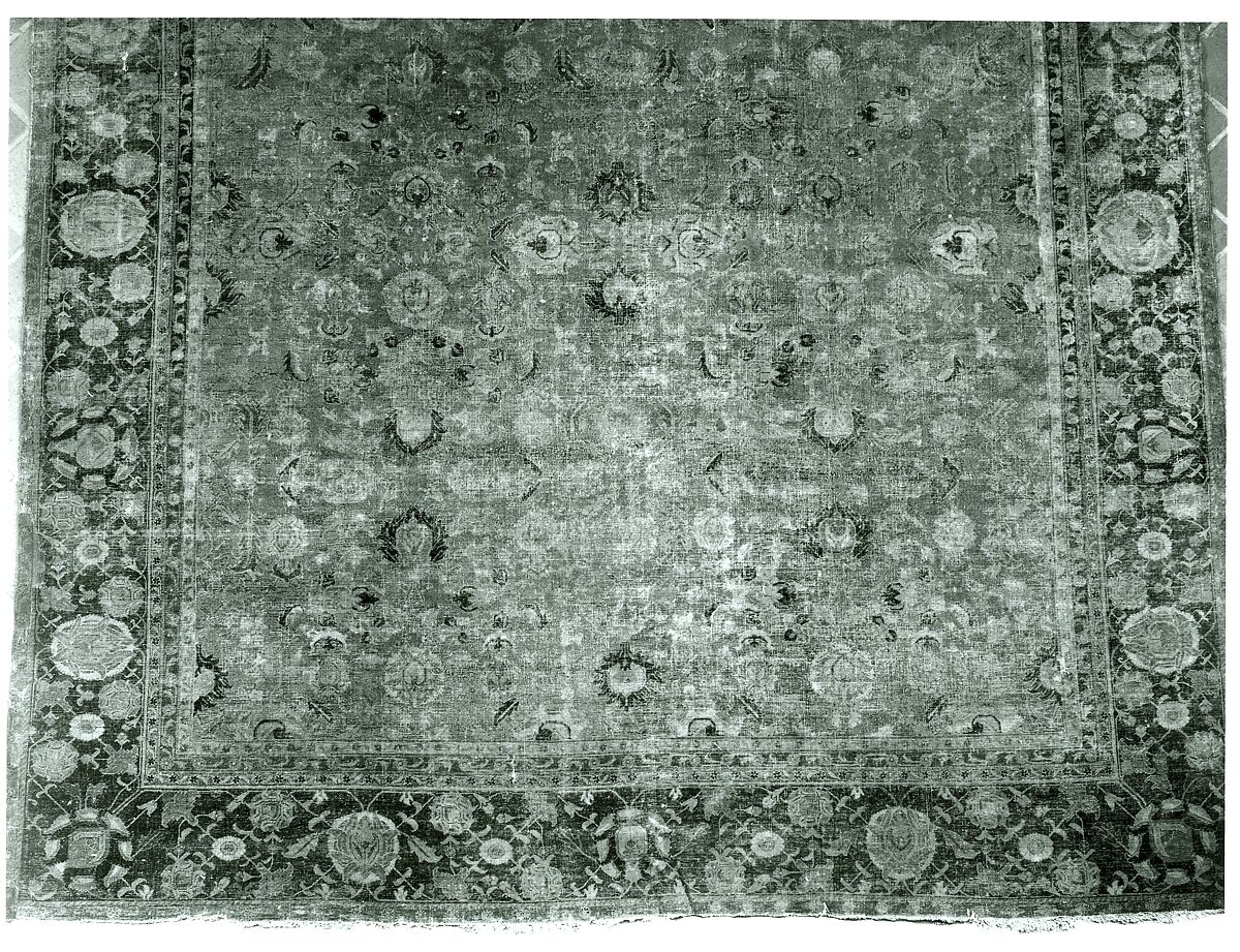 Indo-Persian carpet with repeat pattern of vine scrolls and palmettes., Wool pile on cotton foundation., Indo-Persian