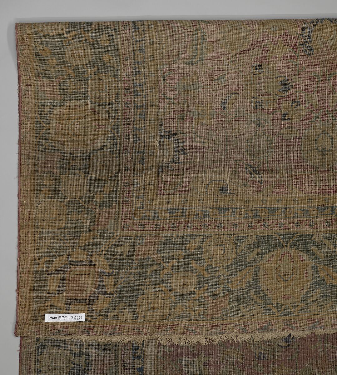 Indo-Persian carpet with repeat pattern of vine scrolls and palmettes., Wool pile on cotton foundation., Indo-Persian