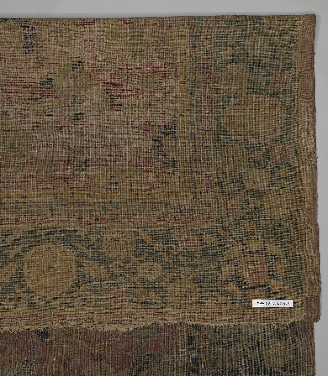 Indo-Persian carpet with repeat pattern of vine scrolls and palmettes., Wool pile on cotton foundation., Indo-Persian