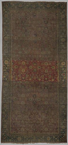 Indo-Persian carpet with repeat pattern of vine scrolls and palmettes.