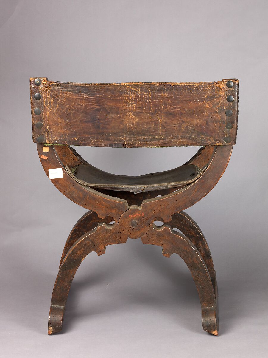 Hip-joint armchair (Dantesca type), Elm (?), bone, carved; leather (?), tooled embroidery, silk velvet, metal., Italian