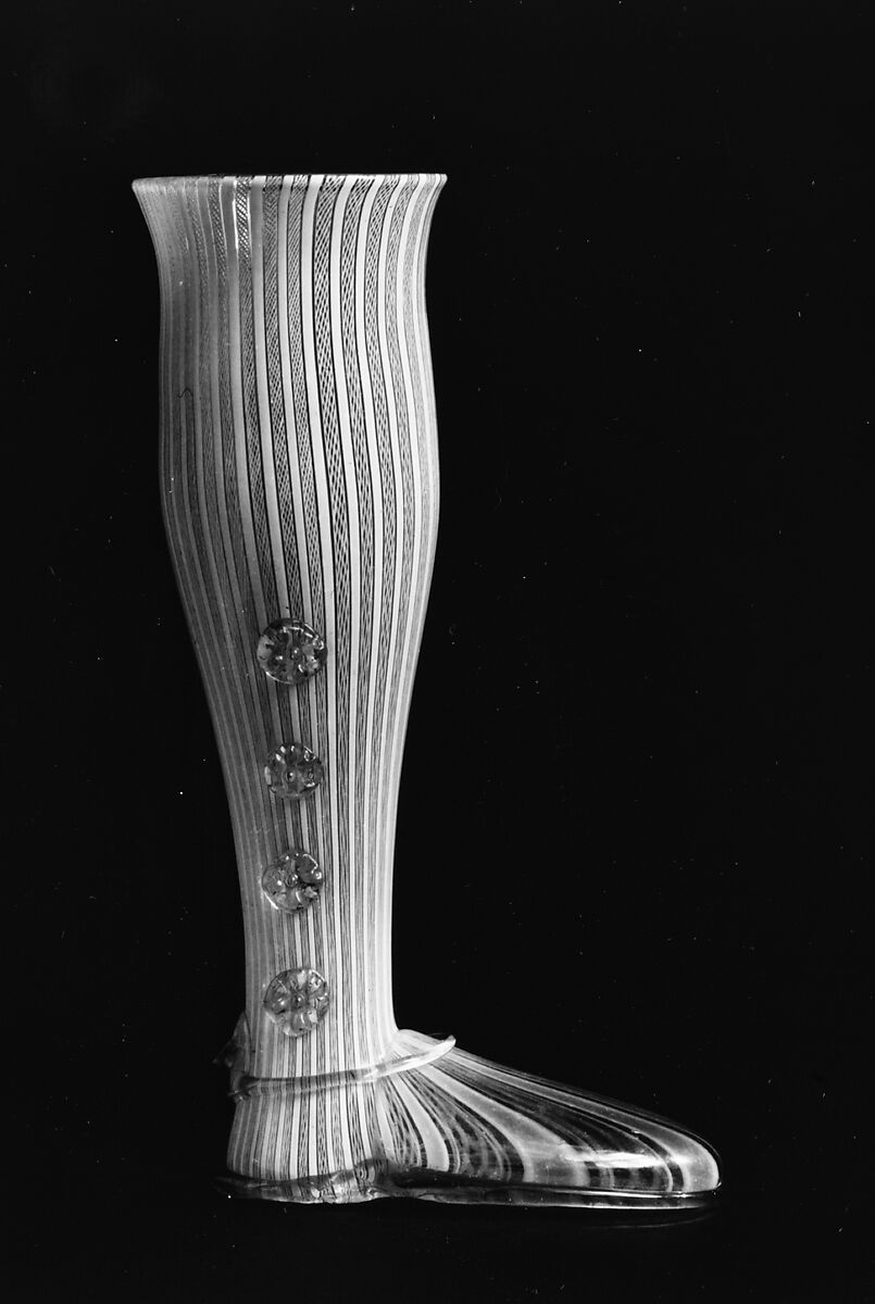 Boot glass, Colorless (gray) and opaque white nonlead glass. Blown, "vetro a retorti", trailed, applied and impressed parts, gilt., Venetian or façon de Venise, probably south Lowlands or Germany 
