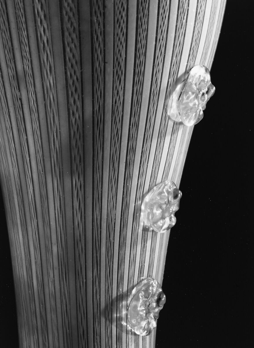 Boot glass, Colorless (gray) and opaque white nonlead glass. Blown, "vetro a retorti", trailed, applied and impressed parts, gilt., Venetian or façon de Venise, probably south Lowlands or Germany