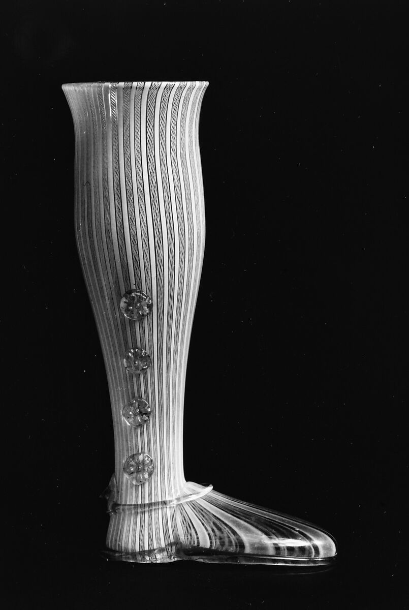 Boot glass, Colorless (gray) and opaque white nonlead glass. Blown, "vetro a retorti", trailed, applied and impressed parts, gilt., Venetian or façon de Venise, probably south Lowlands or Germany