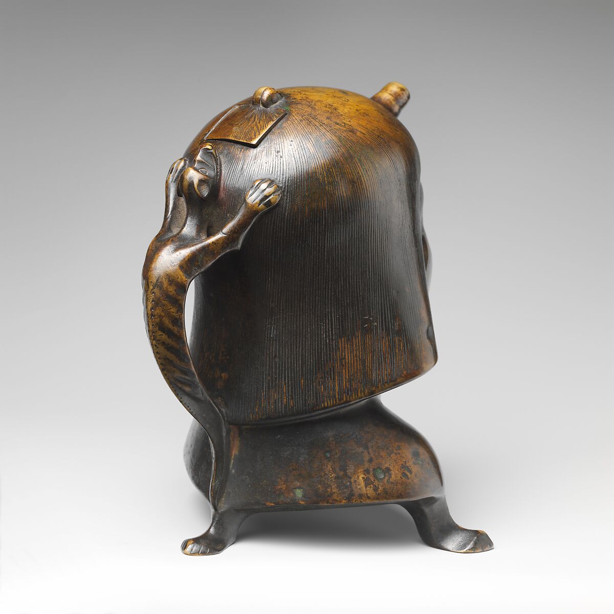 Aquamanile in the Form of a Human Head, Bronze; Ternary copper alloy with a very high percentage of zinc (approx. 68% copper,
approx. 26% zinc, approx. 4% tin), covered with a thin black lacquer patina; traces of cinnabar have been detected on the interior and exterior of the vessel., German or French, Paris (in fourteenth-century Hildesheim style)