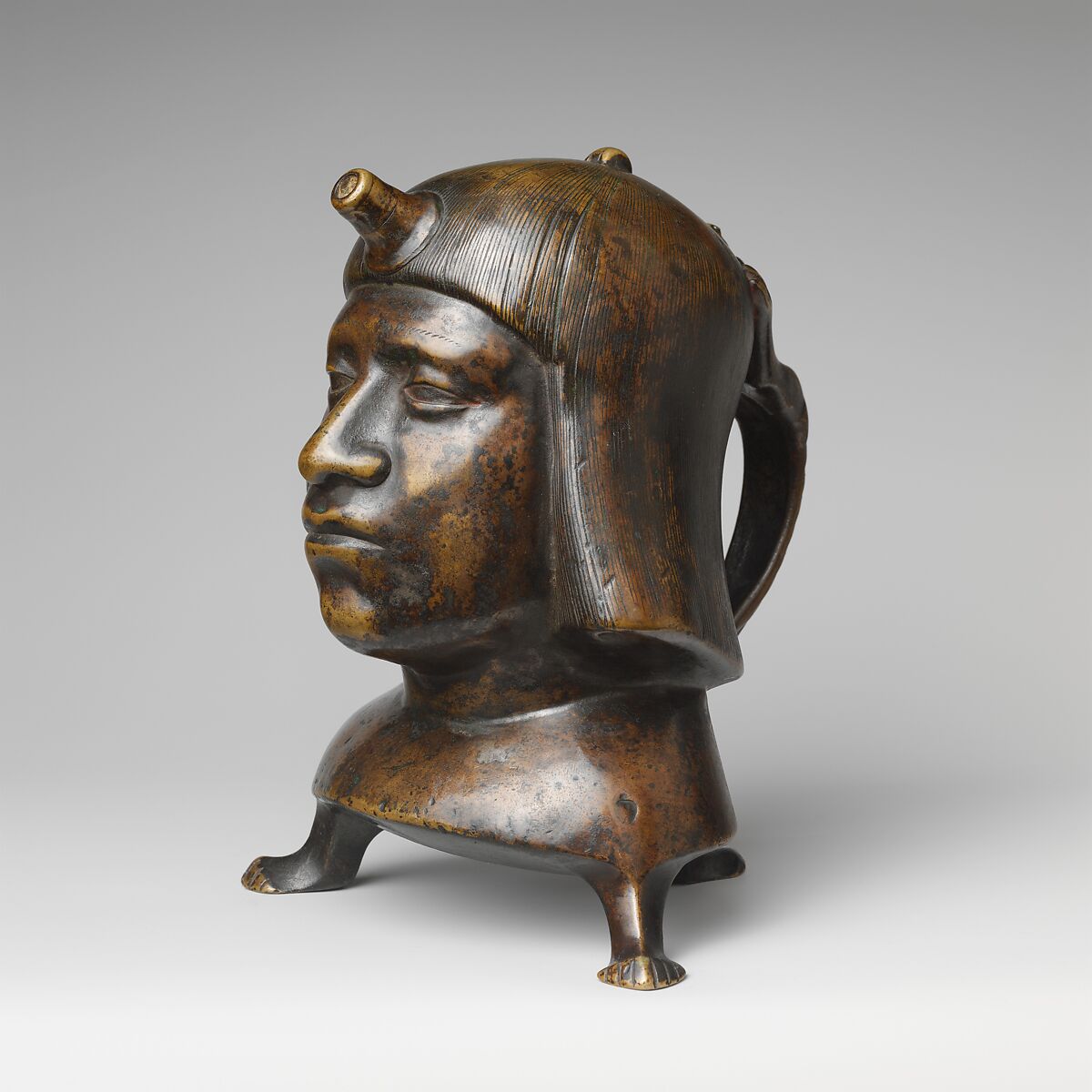 Aquamanile in the Form of a Human Head, Bronze; Ternary copper alloy with a very high percentage of zinc (approx. 68% copper,
approx. 26% zinc, approx. 4% tin), covered with a thin black lacquer patina; traces of cinnabar have been detected on the interior and exterior of the vessel., German or French, Paris (in fourteenth-century Hildesheim style) 