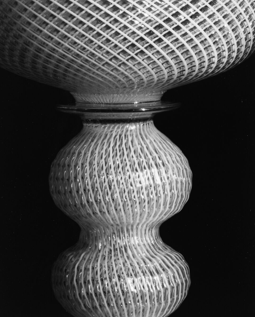 Colorless (slightly tan) and opaque white nonlead glass. Blown, "vetro a reticello"., Italian, Venice