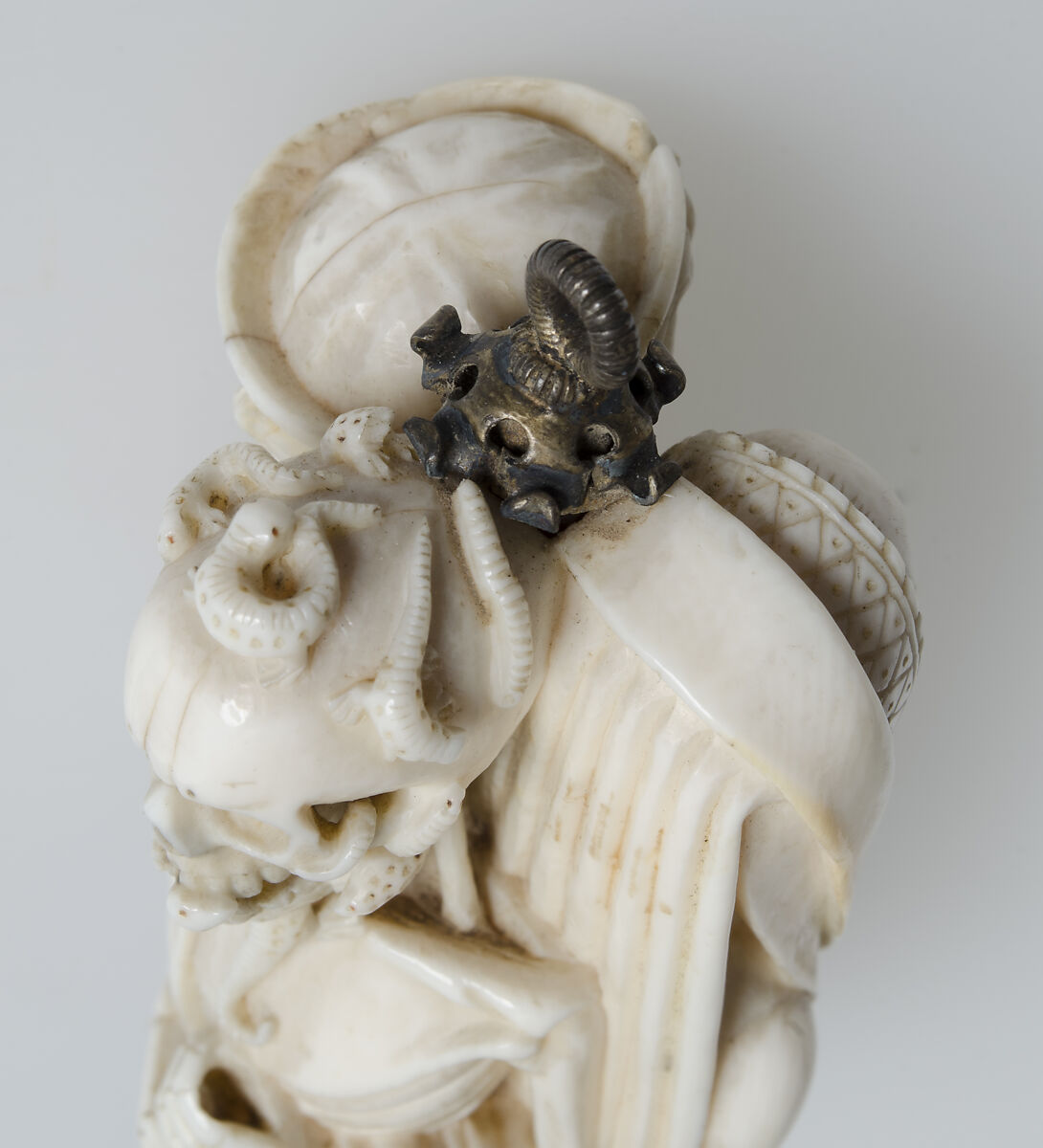Rosary Terminal Bead with Lovers and Death's Head, Elephant ivory, with emerald pendant, silver-gilt mount, North French or South Netherlandish