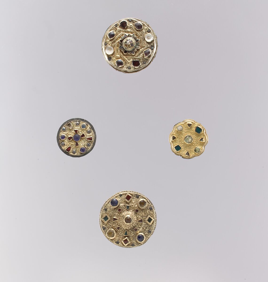 Disk Brooch, Gold sheet, filigree, garnets with patterned foil backings, Frankish