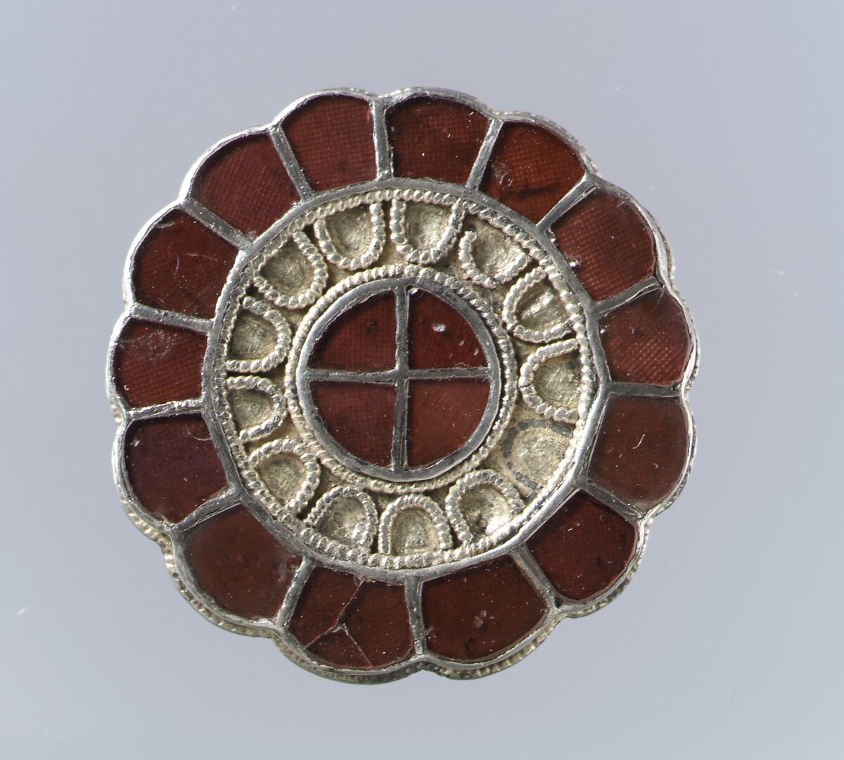 Rosette Brooch, Silver-gilt, garnets with patterned foil backings, Frankish 