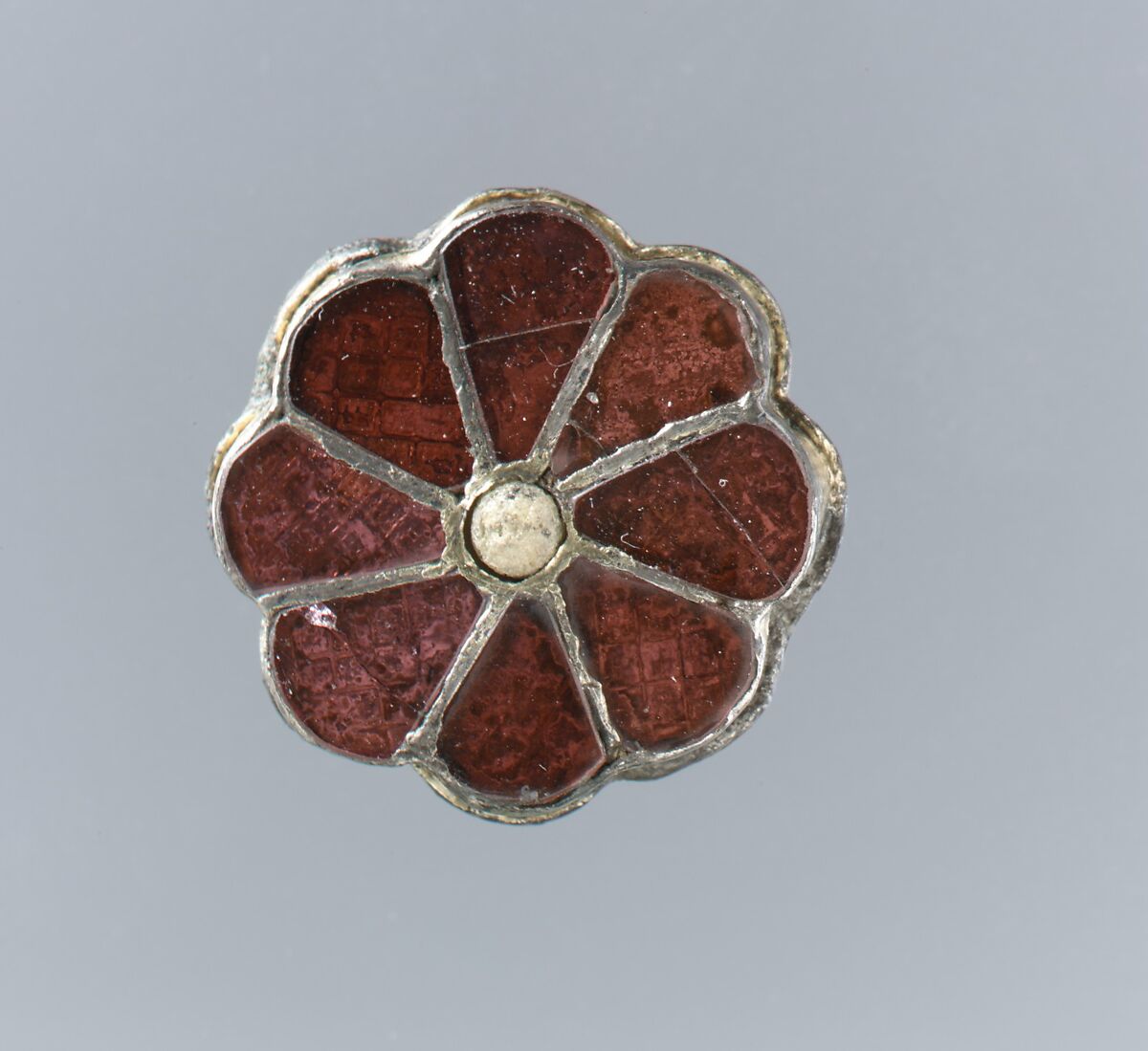 Rosette Brooch, Silver-gilt, beaded filigree edging, garnets with patterned foil backing., Frankish 