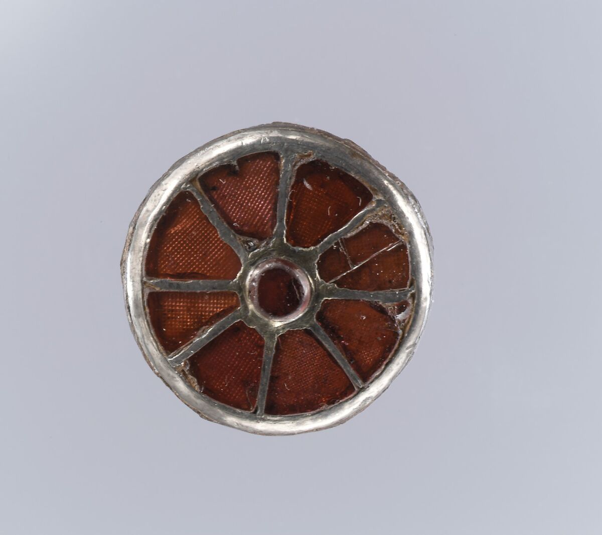 Disk Brooch, Silver-gilt, garnets with patterned foil backings, iron base, Frankish
