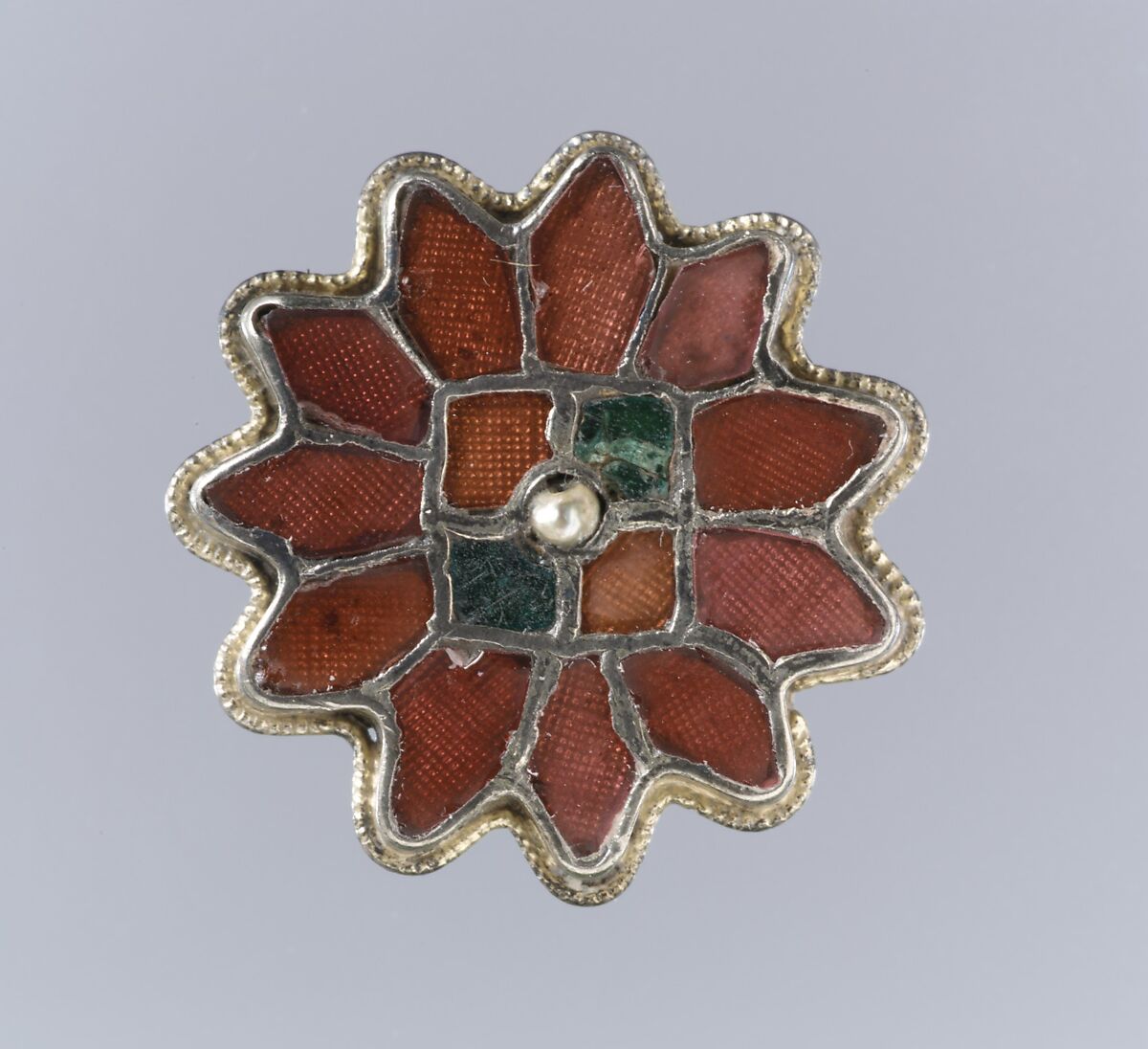 Rosette Brooch, Silver-gilt, garnets with patterned foil backings, green glass, pearl, Frankish
