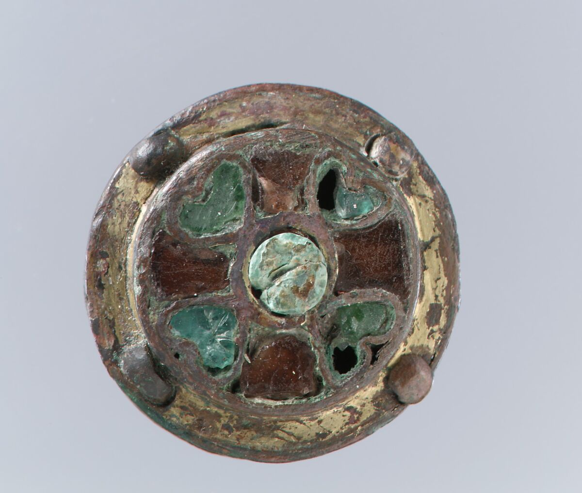 Disk Brooch, Copper alloy, gilded, mother-of-pear; garnets and green glass inlaid with silver foil backings; copper alloy back, no spring/pin extant, Frankish 