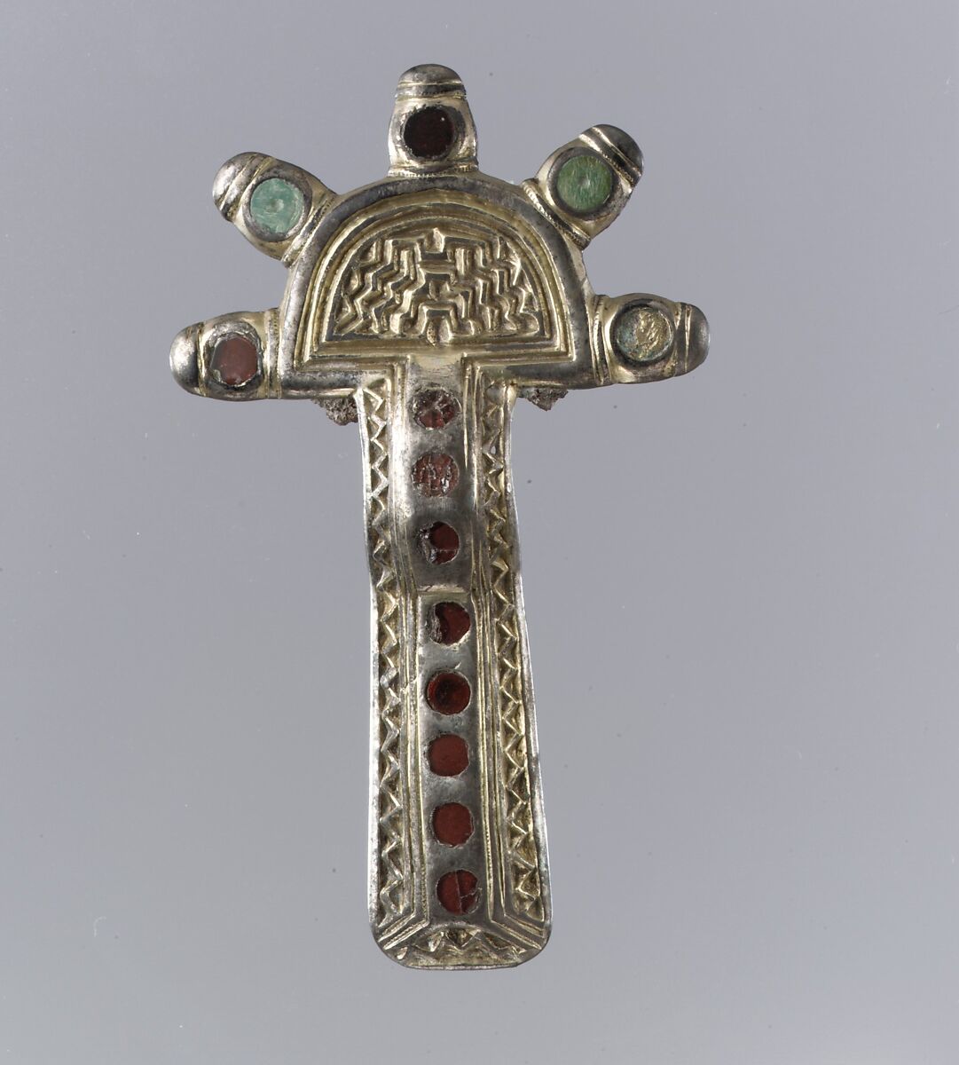 Bow Brooch, Silver, gilt and cast; garnet with unpatterned foil backing; bone; iron spring/pin, Frankish 