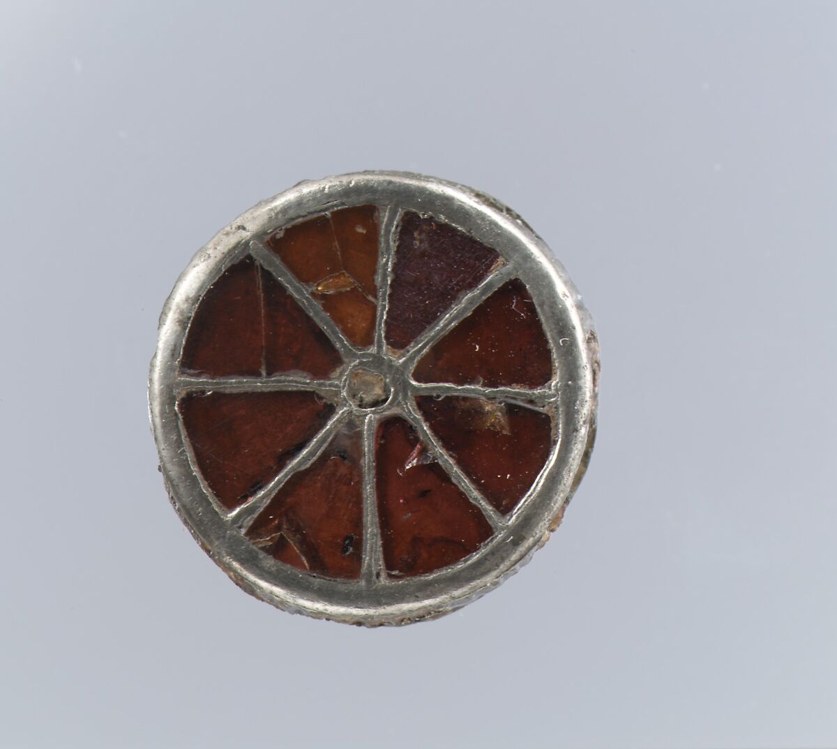 Disk Brooch, Silver, garnets with patterned foil backings, central inlay, Frankish 