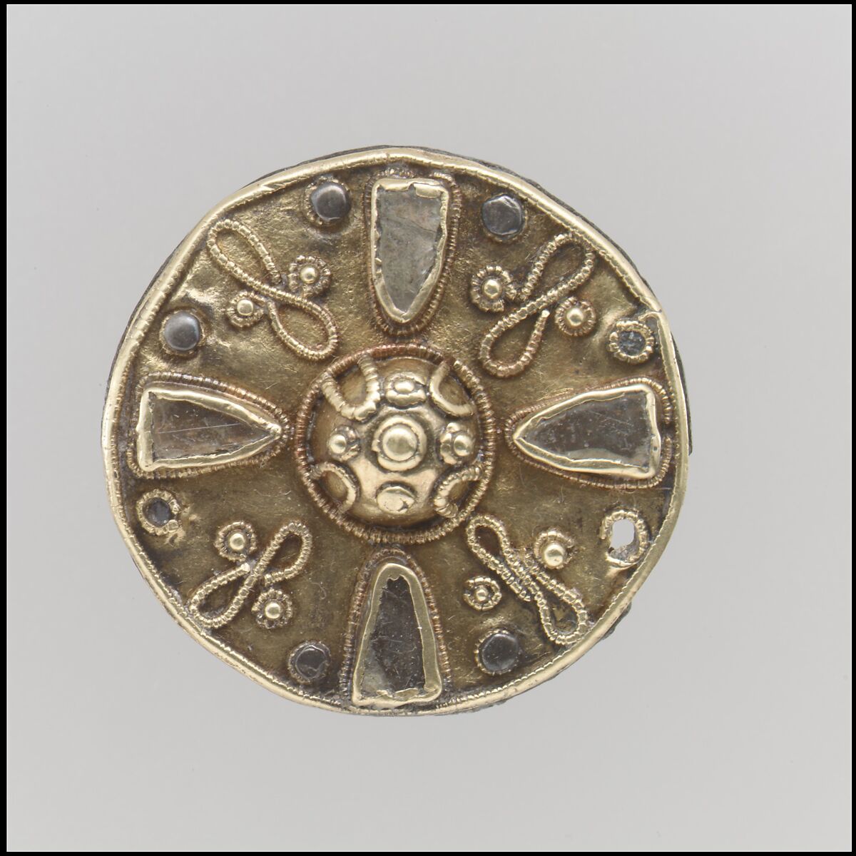 Disk Brooch, Gold sheet, beaded wire; granulation, clear glass inlaid with red glazing on the underside; gold sheet attached to a copper alloy back with silver rivets; no spring/pin or attachment posts extant., Frankish 