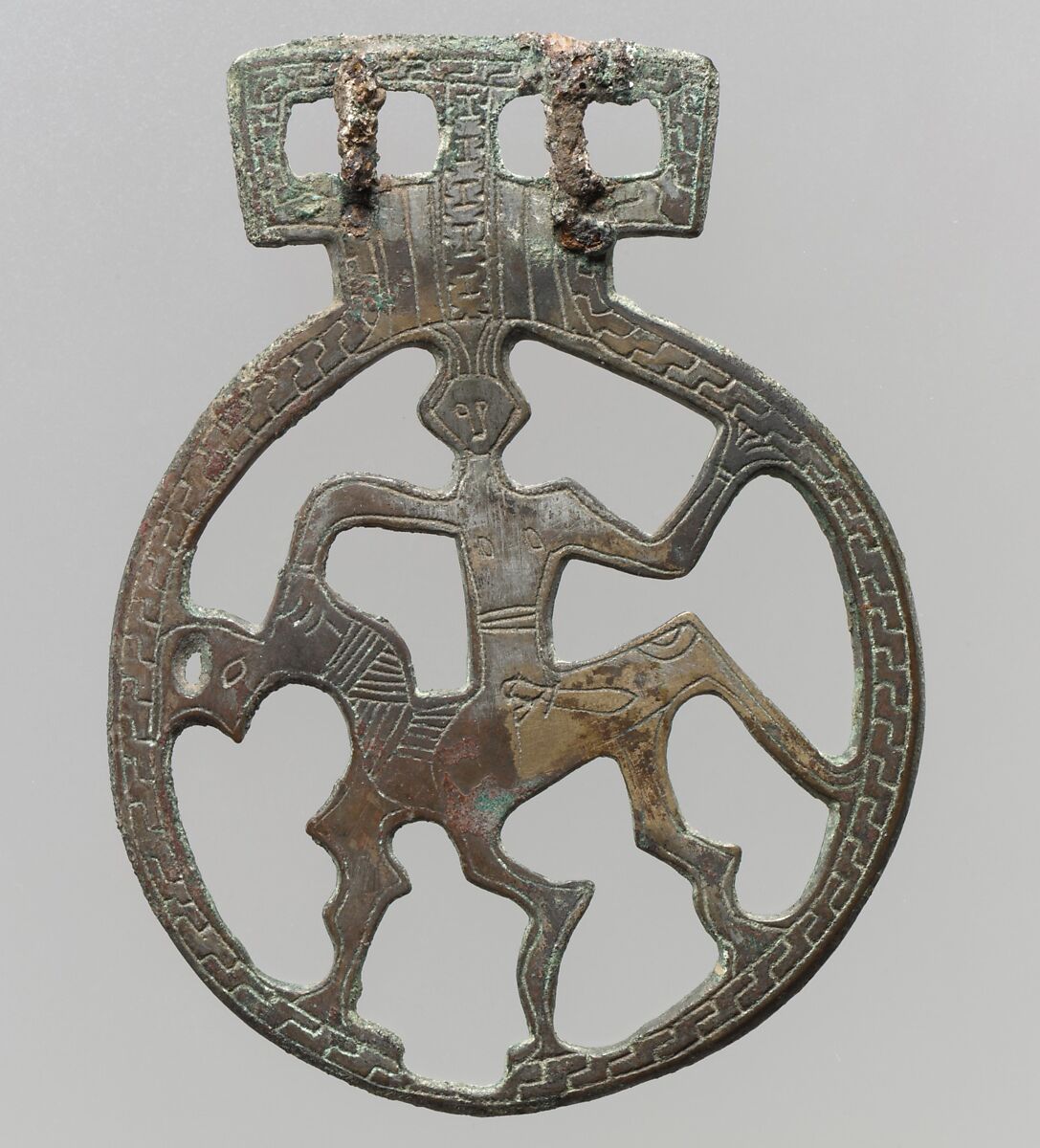 Openwork Belt Fitting, Cast copper alloy - tinned surface, engraved decoration; two integral posts on reverse; iron tongues, Frankish