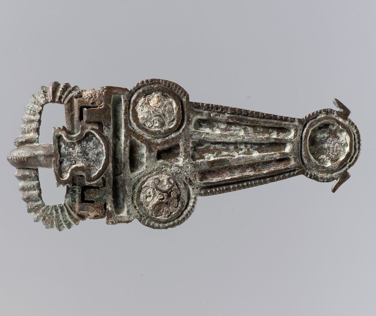 V-Shaped Buckle, Copper alloy, cast (tongue, loop, plaque); red enamel with impressed..., Frankish 