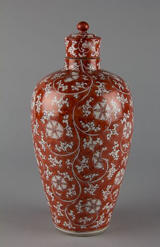 Covered bottle with floral scrolls (one of a pair)