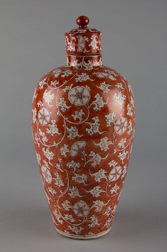 Covered bottle with floral scrolls (one of a pair)