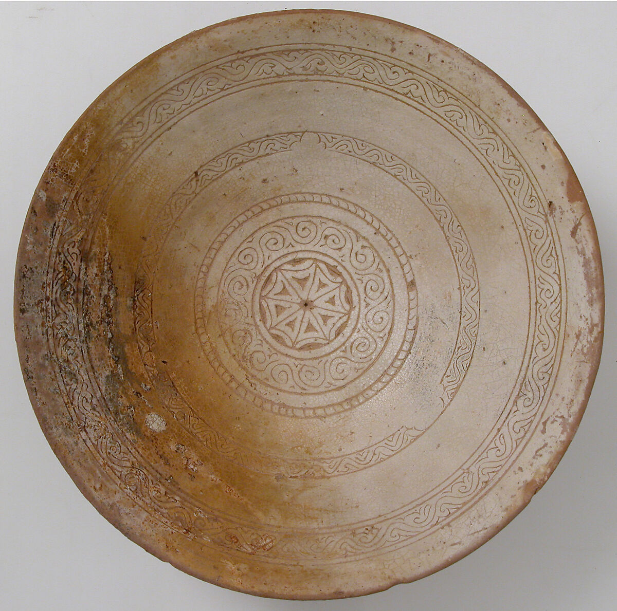 Bowl with Geometric Rosette, Engraved slip ware:orange clay, cream slip, transparent yellowish glaze, Byzantine 