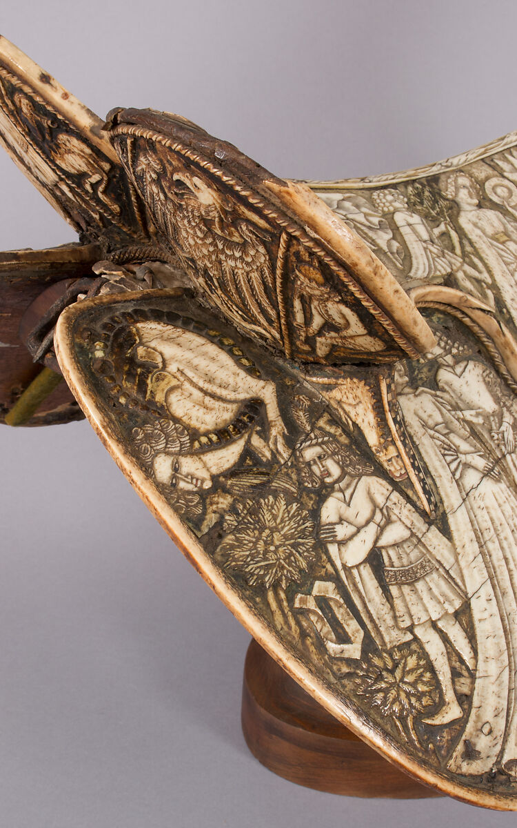 Saddle, Bovine bone (body of saddle), deer antler and bone (decorative elements), limewood, rawhide, birchbark, and metal paint, Central European