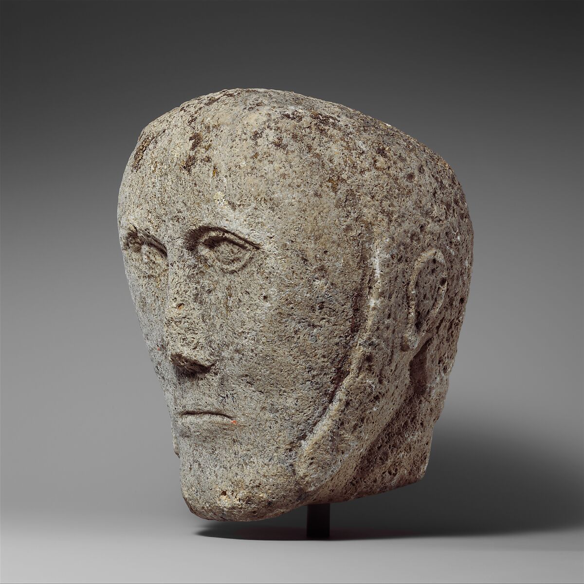 Head of a Man Wearing a Cap or Helmet, Fossiliferous limestone, Celtic
