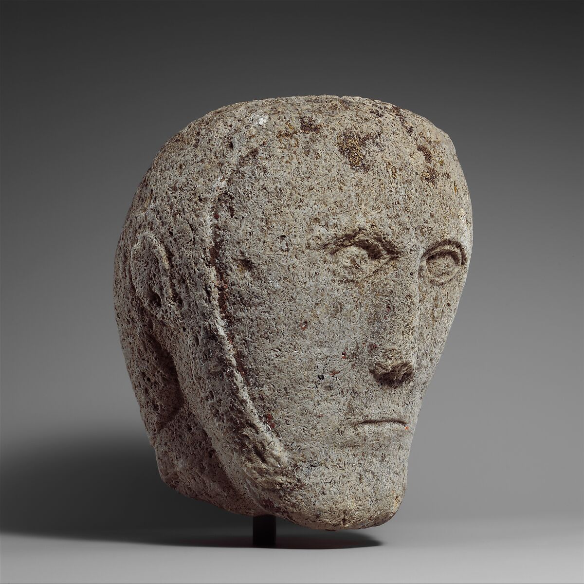 Head of a Man Wearing a Cap or Helmet, Fossiliferous limestone, Celtic