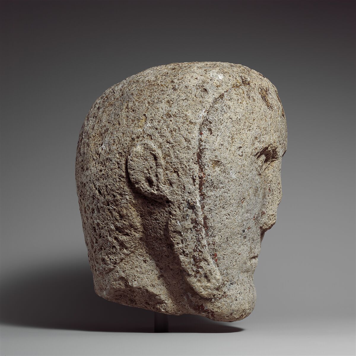 Head of a Man Wearing a Cap or Helmet, Fossiliferous limestone, Celtic