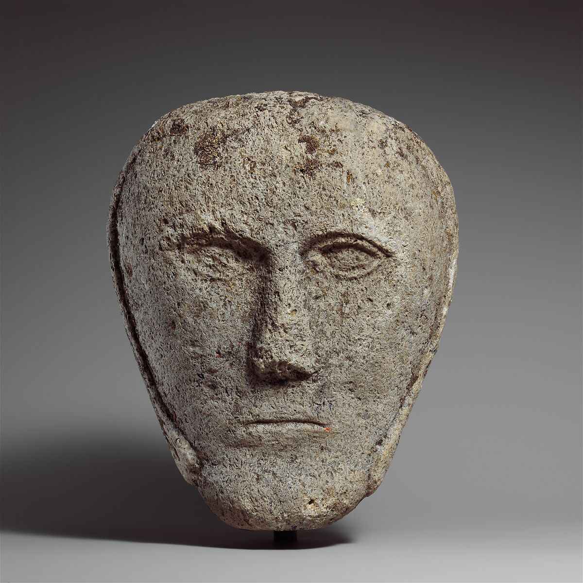 Head of a Man Wearing a Cap or Helmet, Fossiliferous limestone, Celtic 