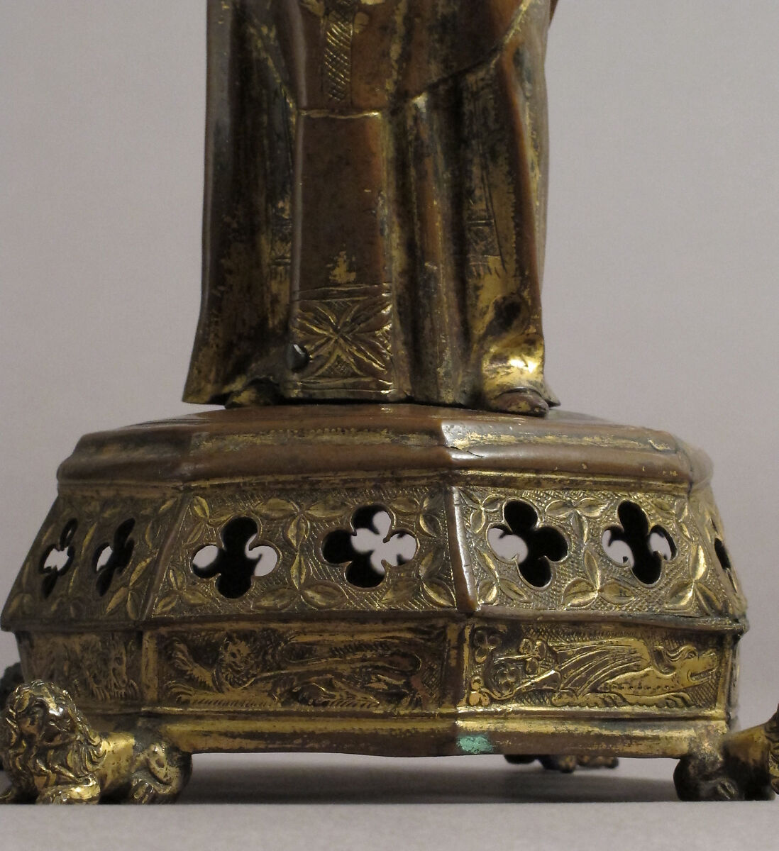 Priest holding a Reliquary, Copper gilt; reliquary vessel: silver, champleve enamel, glass, textile wrapped relic, North French