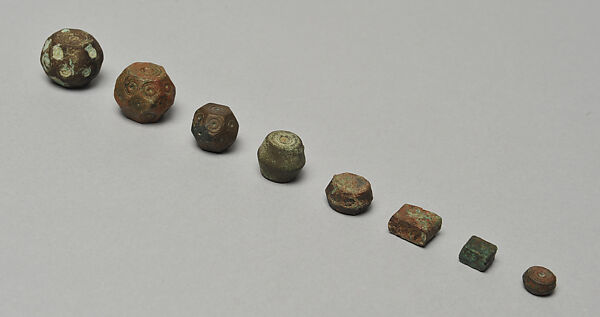 Eight Bronze Weights, Bronze, molded and punch-marked 