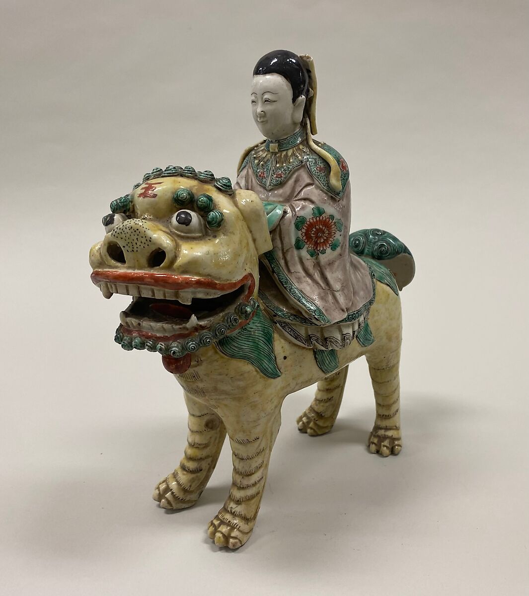 Figure of Bodhisattva Guanyin riding a lion, Porcelain painted in polychrome enamels over the biscuit (Jingdezhen ware), China