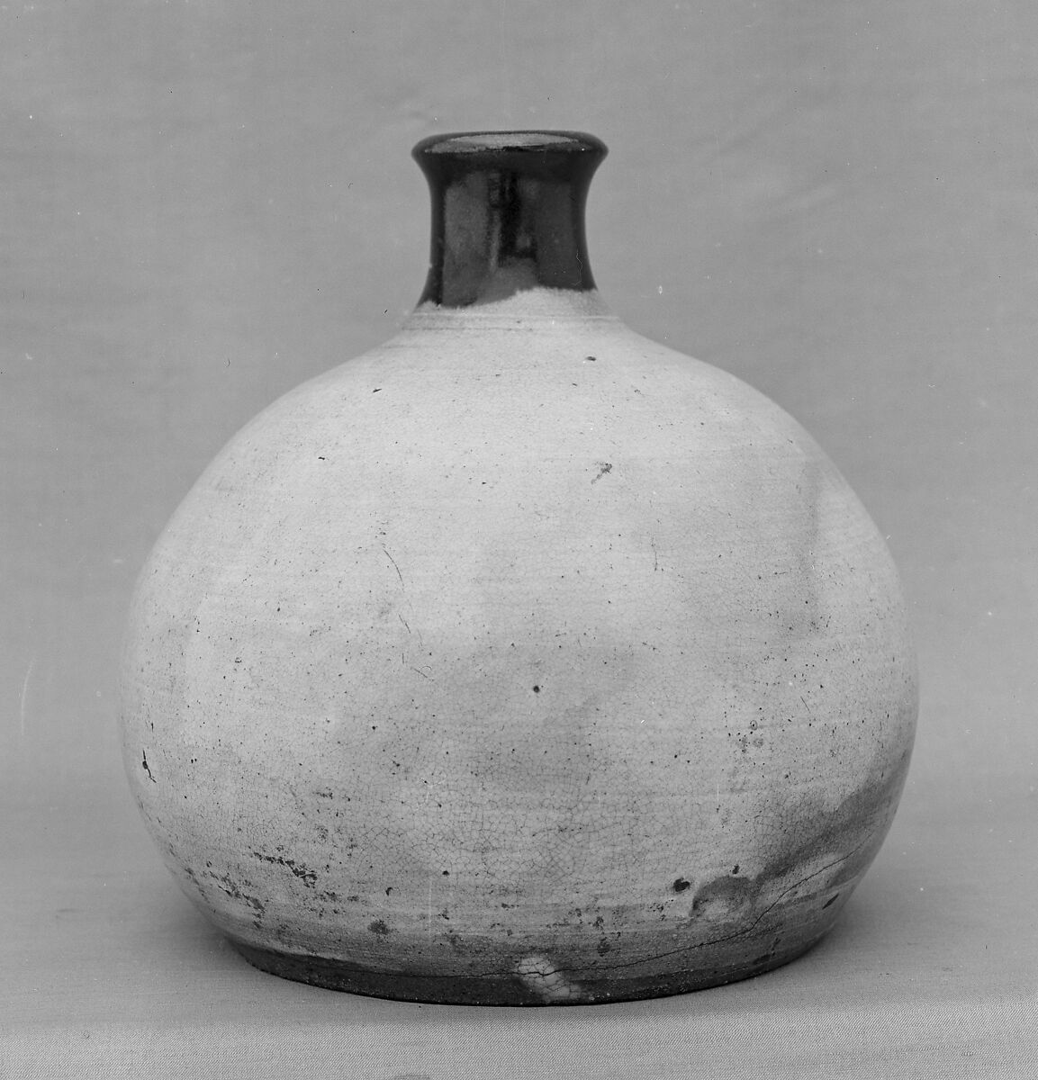 Oil Bottle, Clay covered with white slip and a transparent glaze; darker glaze round the neck and lip (Agano ware), Japan 