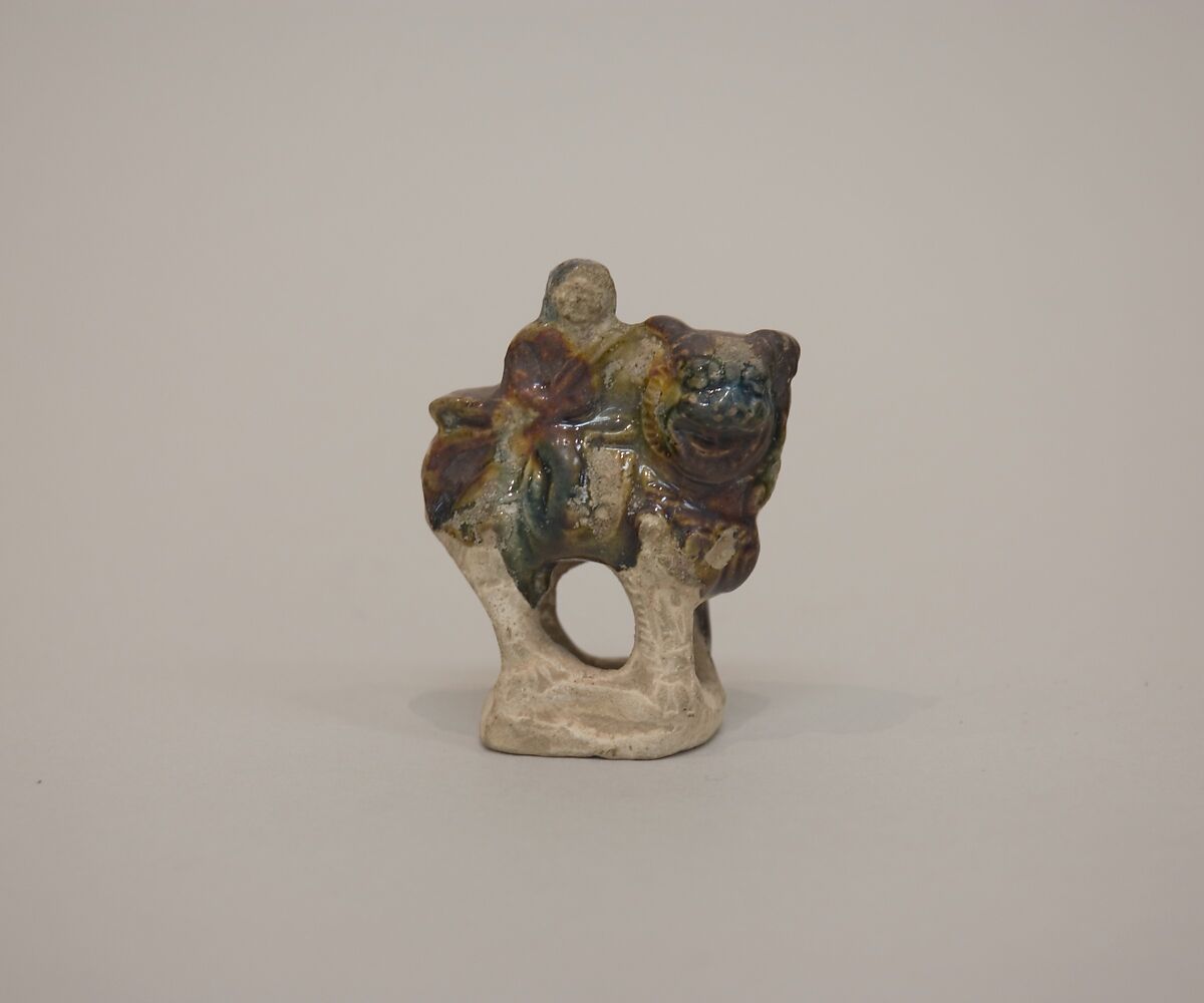 Minature figure of a lion and rider, Earthenware with three color (sancai) glaze, China 
