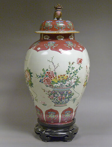 Covered jar with baskets of flowers