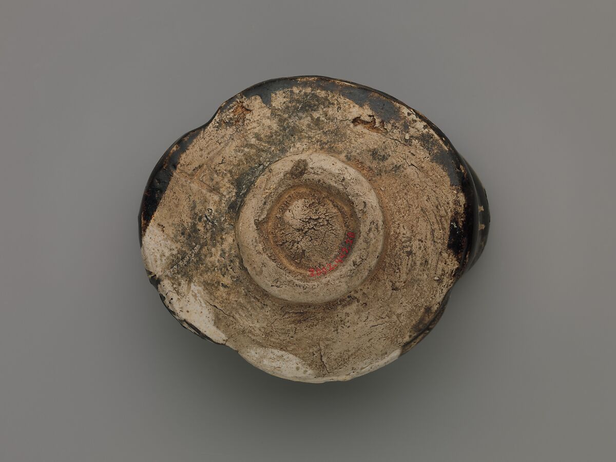 Clog-shaped tea bowl (kutsu-gata chawan) with plum blossoms and geometric patterns, Stoneware with iron-oxide decoration (Mino ware, Black Oribe type), Japan
