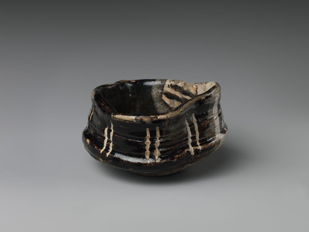 Clog-shaped tea bowl (kutsu-gata chawan) with plum blossoms and geometric patterns, Stoneware with iron-oxide decoration (Mino ware, Black Oribe type), Japan