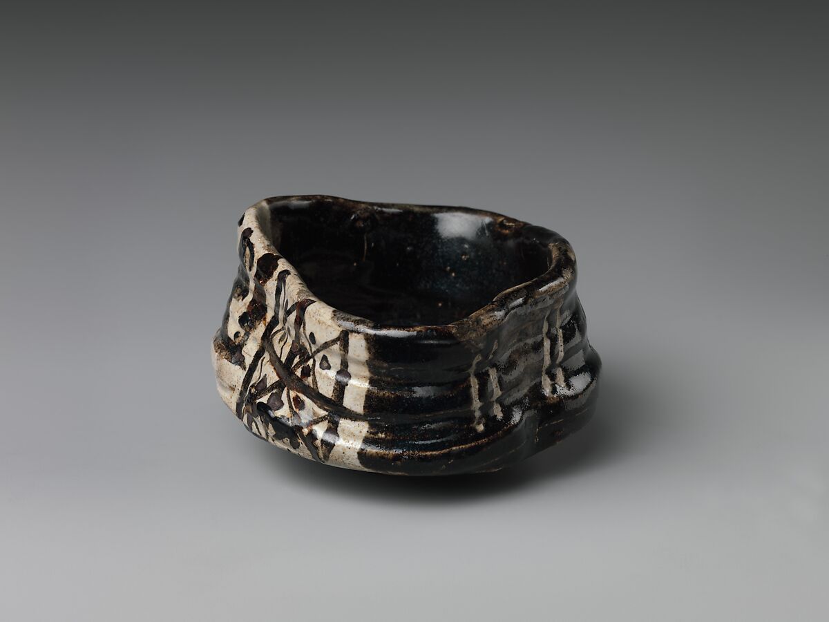 Clog-shaped tea bowl (kutsu-gata chawan) with plum blossoms and geometric patterns, Stoneware with iron-oxide decoration (Mino ware, Black Oribe type), Japan