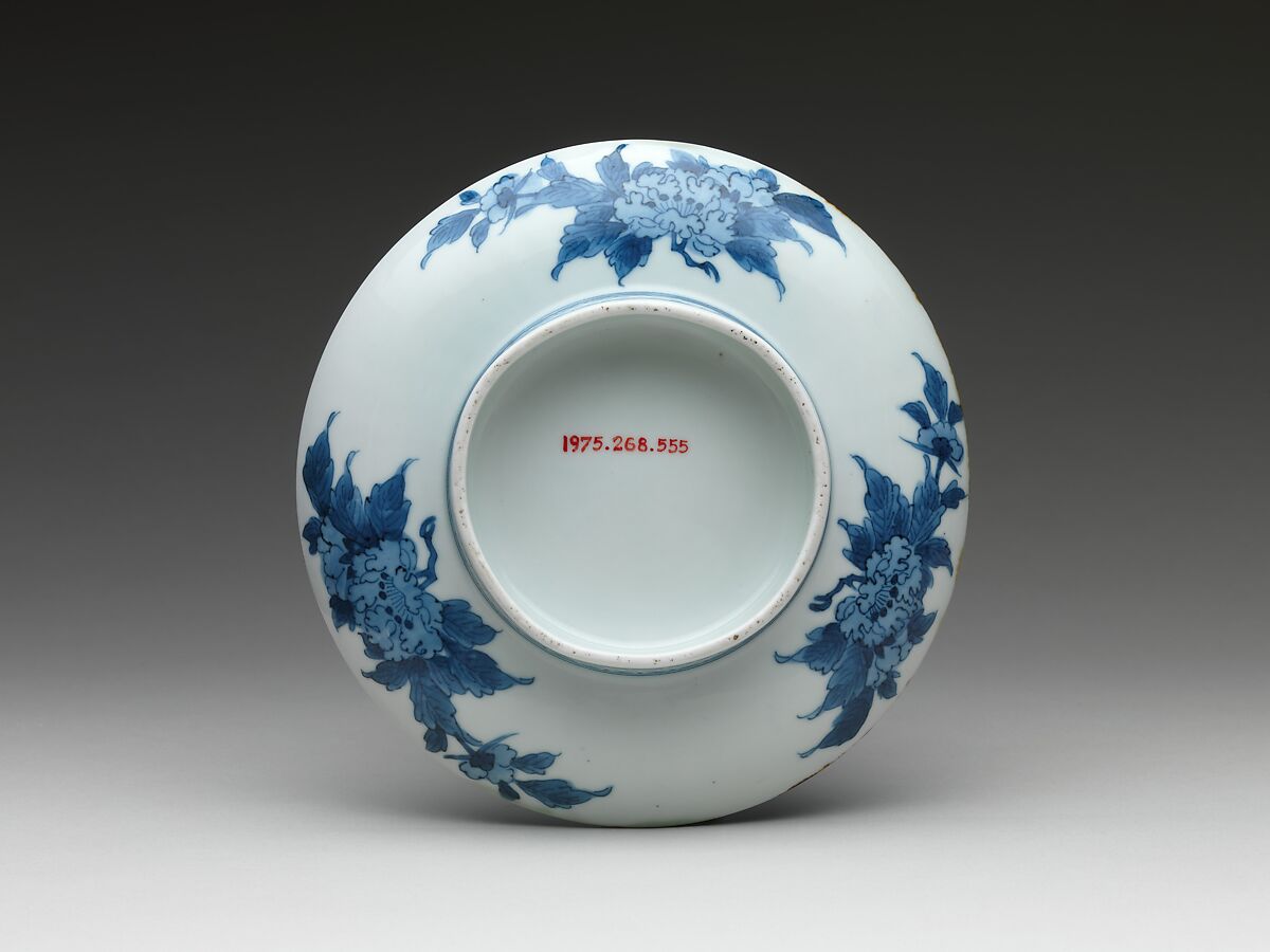 Dish with Cherry Blossoms and Textile Curtains, Porcelain with celadon glaze, partial iron brown glaze, and cobalt blue under transparent glaze (Hizen ware, Nabeshima type) , Japan
