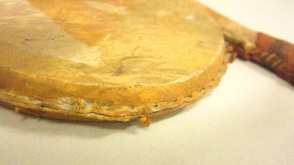 Rattle, Hide, wood, pebbles(?), cord, tin, buckskin, polychrome, Native American (Apache, probably)