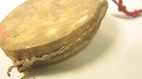 Cici'Gwan, Wood, deerskin, cord, pebbles?, yarn, Native American (Chippewa - Ojibwa)