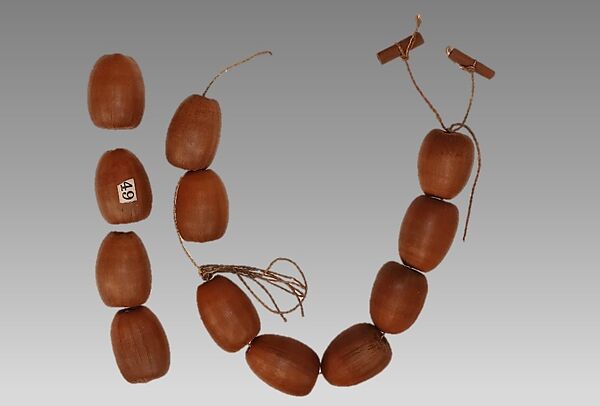 Li-Ba-Li-Ba-Ba (acorn lipper), Acorns, fiber cord, wood, Native American (Yukian) 