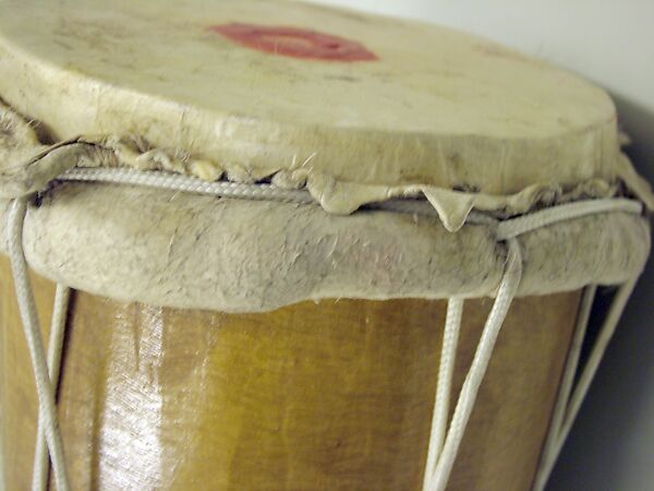 Batá, Brandon Rosser (American, active New York, late 20th century), Sweet maple, polyurethane finish, brass and copper bells, nylon, steel bolts, jet bead, deer skin heads, golden oak stain, red clay, American