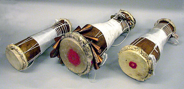 Batá, Brandon Rosser (American, active New York, late 20th century), Sweet maple, polyurethane finish, brass and copper bells, nylon, steel bolts, jet bead, deer skin heads, golden oak stain, red clay, American